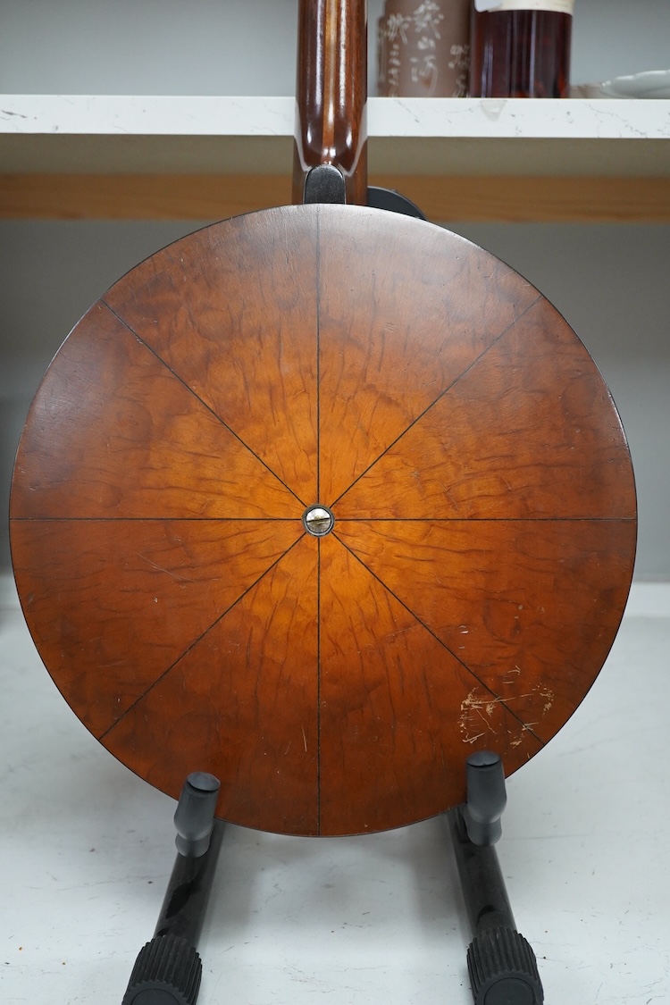 A cased Vega 4-string tenor banjo stamped M. Roccia, steel body with veneered back, the case embossed with; Ronald Quilter, 10, Cadogan Lane, London S.W.1., overall length 82cm